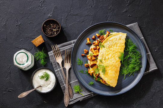 Egg omelet with fried wild chanterelles and dill