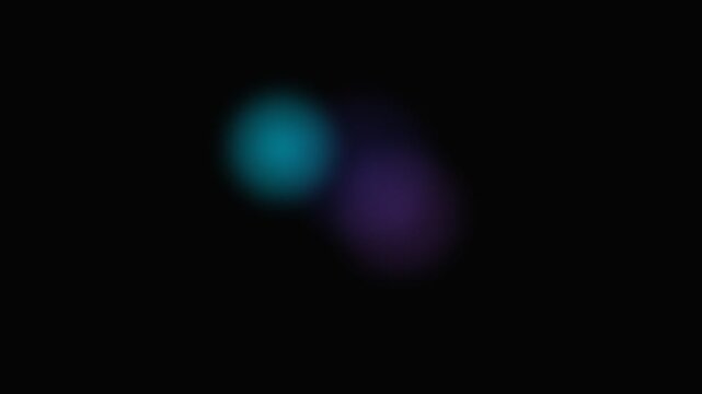 Two soft glowing orbs of purple and blue light floating in deep darkness