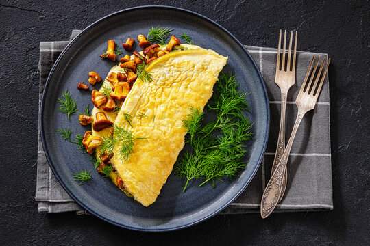 Egg omelet with fried wild chanterelles and dill