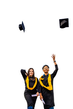 Graduates celebrating academic achievement, throwing caps in the air with diplomas. PNG