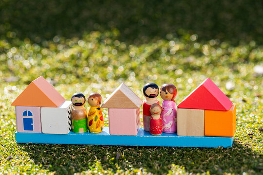 Housing affordability and family concept shown with coloured homes made of blocks