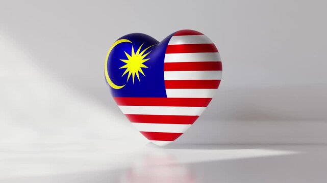 A heart shape appears in the center of the screen featuring the flag of Malaysia. The animation shows the heart rotating slowly against a plain background