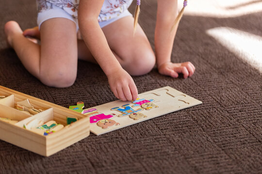 child playing with bear puzzle with emotions on faces