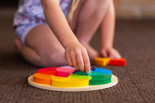 child doing colourful puzzle motor skills developmental toy