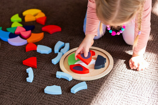 kid playing with wooden ladybird puzzle motor skills development toy