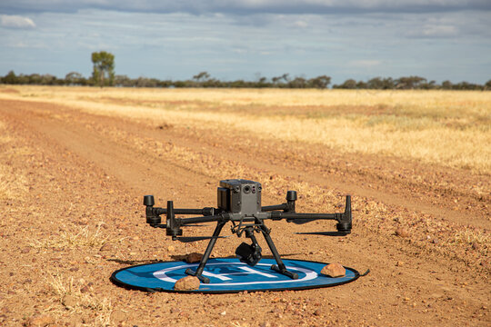 Large agricultural drone ready for takeoff on a landing mat