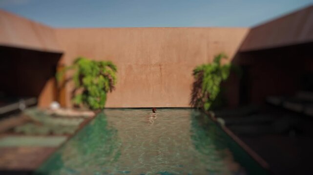 Woman swimming in a luxury riad pool