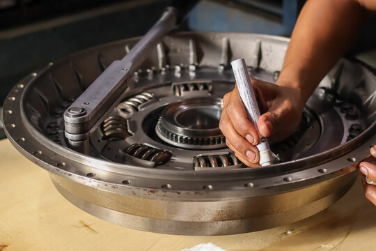 Mechanic marking bolts on clutch pressure plate assembly