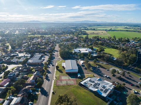 Aerial view over Singleto Heights towards school and club building with carpark