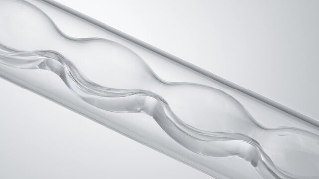 Macro video of pure clear liquid flowing in glass condenser tube, medical science chemistry lab cosmetic skincare serum distillation