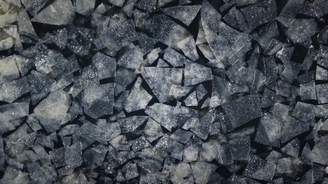 Cinematic drone ascent reveals drifting Baltic ice mosaic, Daugava river mouth