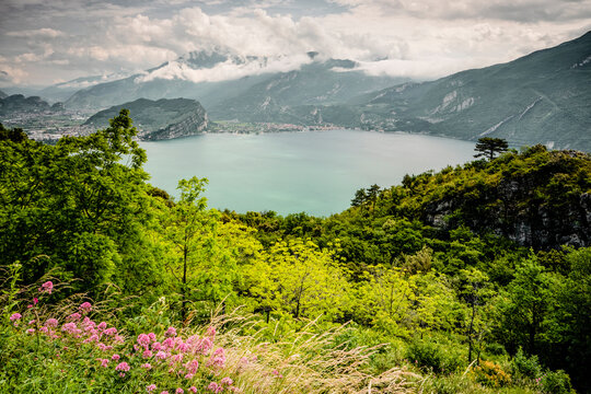 Panoramic mountain landscape overlooking Lake Garda featuring lush forest and nature tourism destination for outdoor exploration, Arco, Trentino, Veneto, Italy.