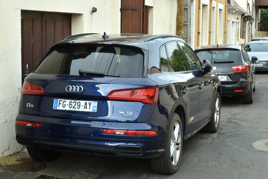 St Amamnd Montrond - France - 14 july 2026 - Rear view of a blue Audi Q5 35 TDI luxury SUV parked on a quiet residential street. Modern sport utility vehicle in an urban neighborhood.