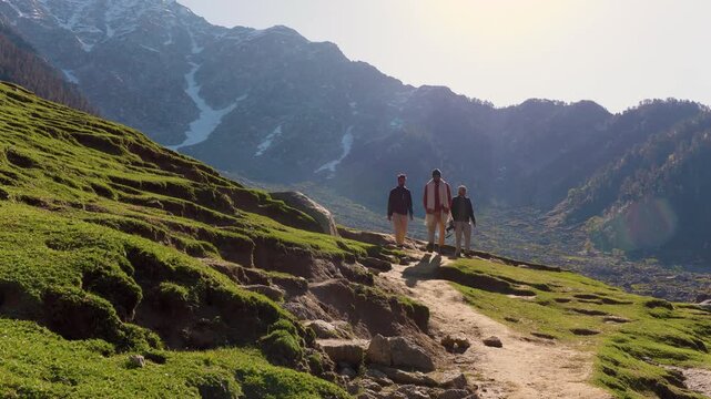 Hikers trekking in mountains. People walking on trail, Kareri Lake, Dharamshala, Himachal Pradesh