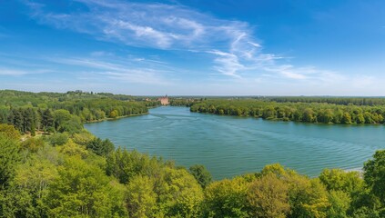 Fototapeta premium Scenic Lake View Surrounded by Lush Greenery Under Clear Blue Sky