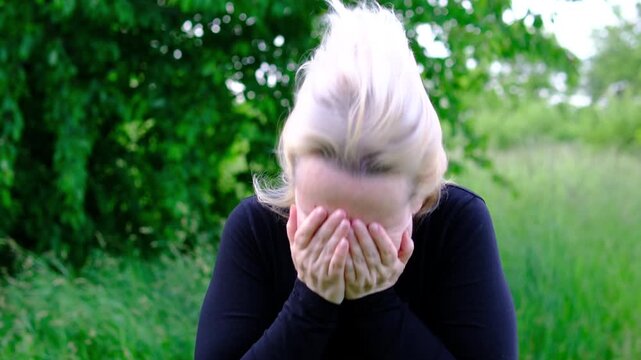 Persistent nasal discomfort causes a woman to rub nose and react repeated sneezes. highlights airborne irritants pollen exposure seasonal sensitivities and challenges of outdoor activities.