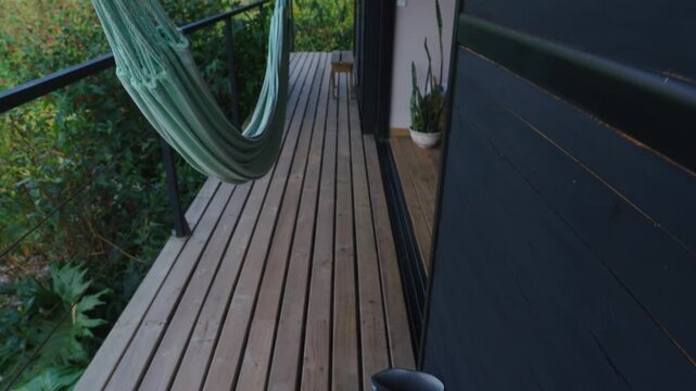 Terrace or balcony with a hammock amidst a bucolic landscape in the mountain countryside