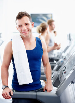 Fitness, portrait and happy man on treadmill at gym for health benefits, wellness or endurance workout. Exercise club, cardio machine and person with wellbeing, training or practice with smile