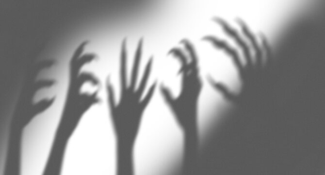 Spooky monster shadows with long sharp claws reaching out in the dark