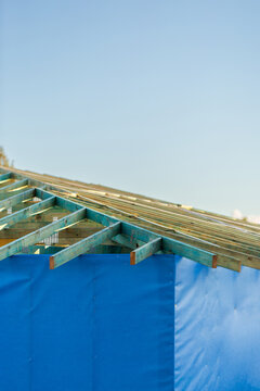 wooden roof structure of house under construction during housing crisis