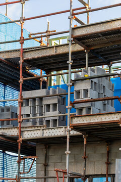 multi storey commercial worksite with scaffolding rising up around building under construction