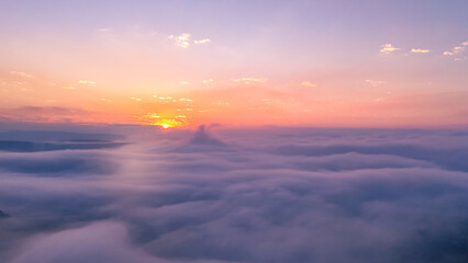 Obraz premium Aerial sunrise view with mist drifting gently across African valley