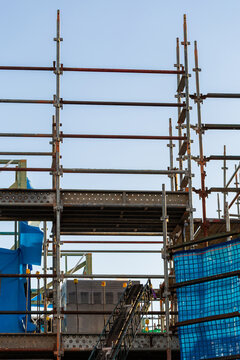 multi storey commercial worksite with scaffolding rising up around building under construction