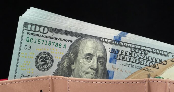 100 dollars banknotes in a wallet. A wad of american dollars in wallet. Cash, finance, savings, wealth. New 100 dollar bills, USD