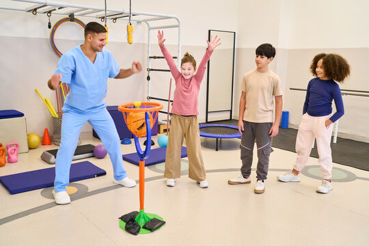 Pediatric physiotherapy session, children rehabilitation exercises with therapist in a pediatric rehab center, motor skills training and balance training, physical therapy session