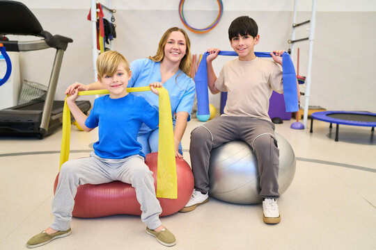 Pediatric Physiotherapy Session with Children and Therapist, Rehabilitation Exercises for Motor Skills, Balance Training in Clinic, Pediatric Rehab Center