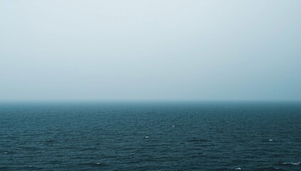 Fototapeta premium Calm ocean surface under a gray sky