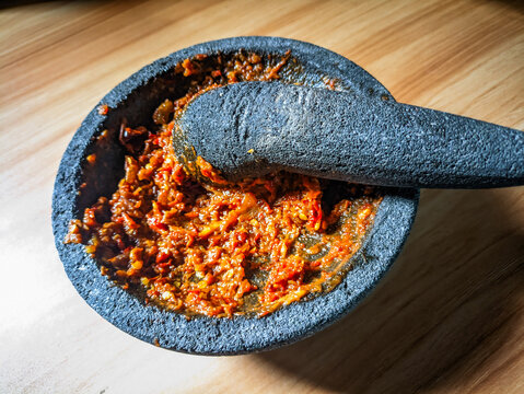 Traditional Indonesian sambal in stone mortar and pestle.