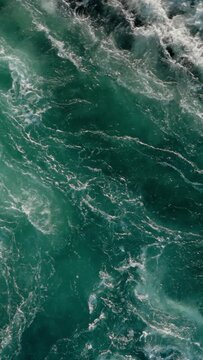 Blue waves of water of the river and the sea meet each other during high tide and low tide.