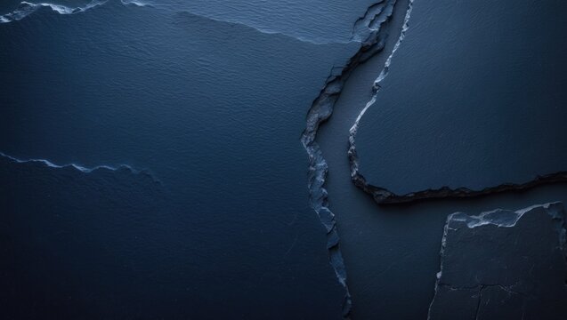Navy blue background of natural slate. Close-up texture of stone. Macro view of graphite backdrop.