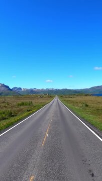 Vertical video Driving a Car on a Road in Norway at dawn.