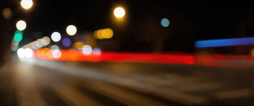 Blurry Nighttime Urban Street Scene with Colorful Light Trails
