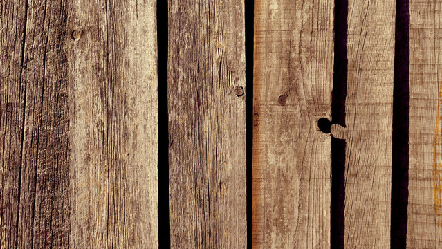 Weathered wooden fence texture, rustic old timber planks close up, aged wood panel background, vertical board pattern, vintage carpentry surface