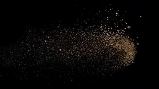 Super Slow Motion Shot Flying Soil Isolated on Black at 1000fps.