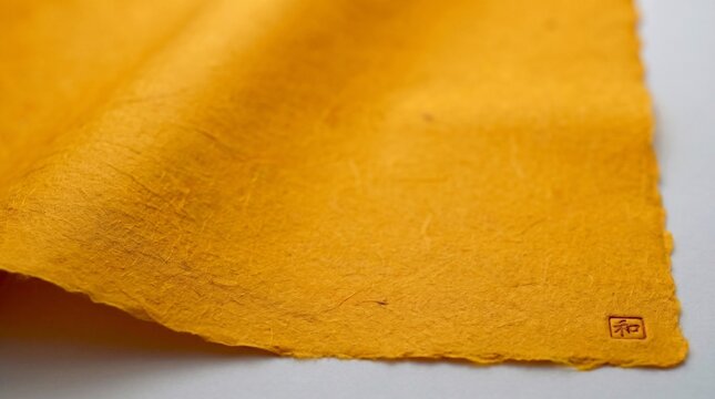 High-resolution Japanese handmade Washi paper background in traditional Yamabuki-iro bright golden yellow color with deckled edge