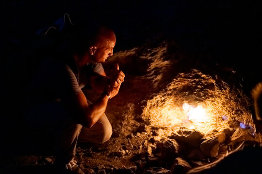 Bald Man Crouches and Watches Eternal Flame at Yanartas Night
