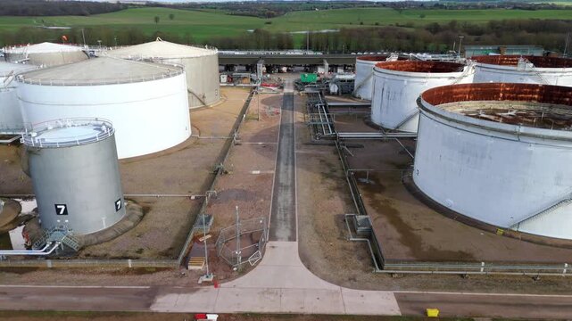 Horizontal drone pan across national grid energy reserve and fuel terminal facilities