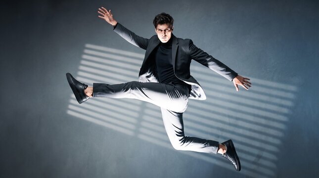 Man in Black Suit Jumping with Dynamic Energy