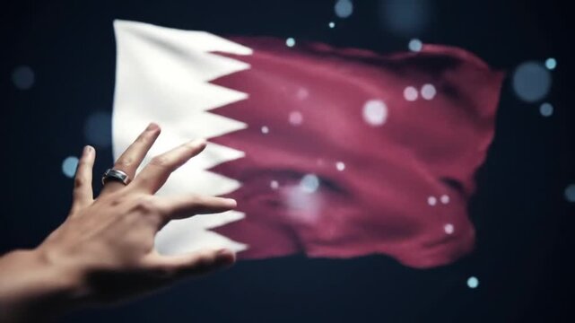 Hand reaching toward Qatar flag in dark setting with bokeh