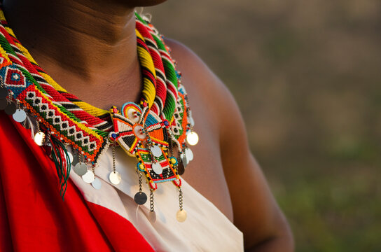 Kenya, Laikipia, Il Ngwesi, Masai man wearing traditional clothes and adorned with elaborate beadwork jewellery