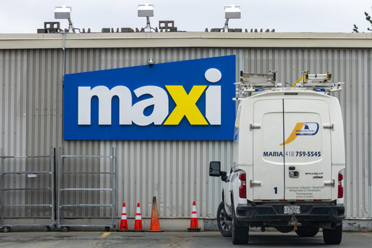 Campbellton, New Brunswick, 06 June 2026 : A white service van from Refrigeration Fortier is parked in front of a Maxi grocery store.