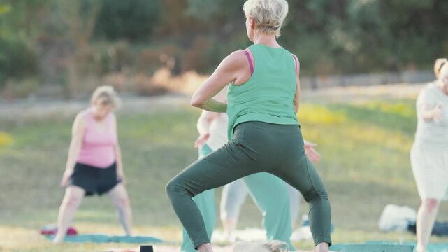 Senior women practicing tai chi in an outdoor class