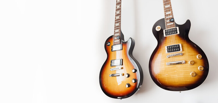 May 11, 2026, Częstochowa, Poland - Gibson and Ibanez Electric Guitars Hanging on White Wall