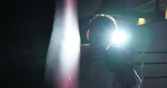 Dynamic point-of-view shot of a boxer throwing punches toward the camera during a training session with a coach. Camera reacts to every strike, creating an immersive first-person perspective that