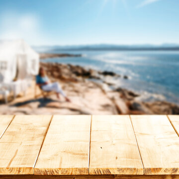 Lake camping with mountain view and wooden table with copy space &ndash; outdoor summer adventure concept.