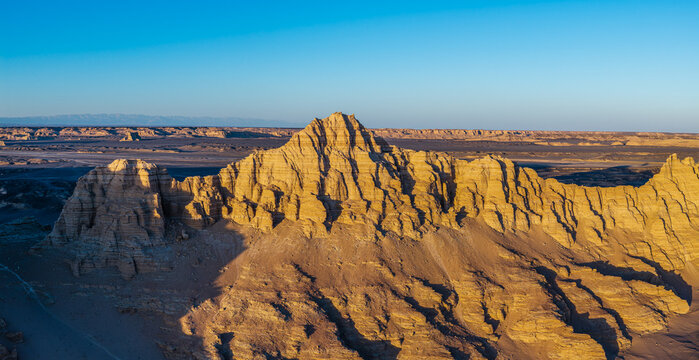 Aerial view of majestic yardang landforms in Gobi Desert at sunset, Dahaidao, Xinjiang, China